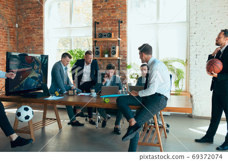Happy colleagues having fun in office while their colleagues working hard Happy colleagues having fun in office while their colleagues working hard 69372074
