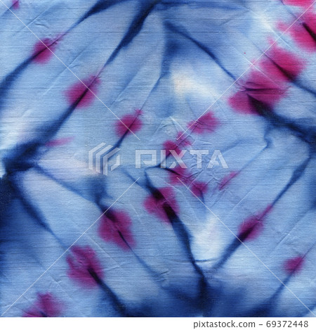 Tie dyed pattern on cotton fabric for background. 69372448