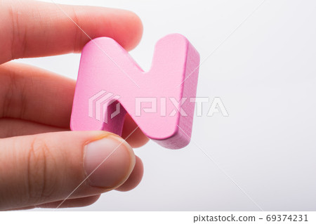 Hand holding Letter cube  N of  Alphabet 69374231