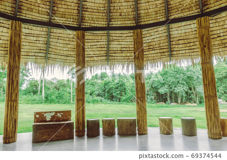 Many bamboo bindings are tied together with hemp ropes to be used as pole for resting cottage. Selective focus on hemp ropes. 69374544