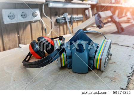 Young adult caucasian mid aged professional female carpenter grinding raw wood with orbital sander  69374835