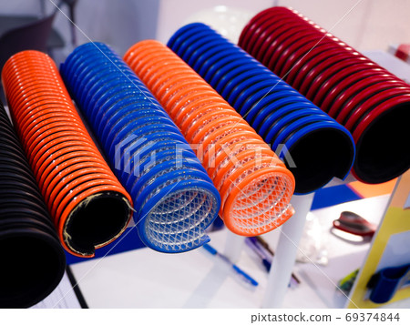 flexible duct hose tubing multicolor used in industrial applications.close-up. flexible duct hose tubing multicolor used in industrial applications.close-up. 69374844