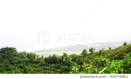 Green glade in a mountain valley Green glade in a mountain valley 69374961