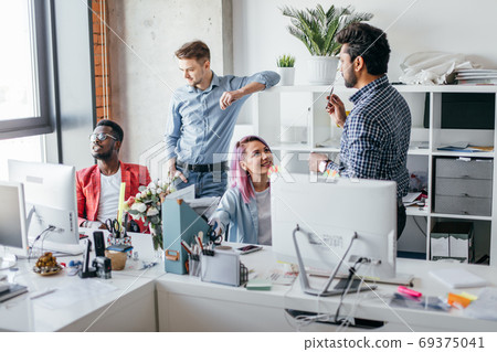 Business people at work in a busy luxury office space Business people at work in a busy luxury office space 69375041