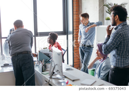 Business people at work in a busy luxury office space 69375043