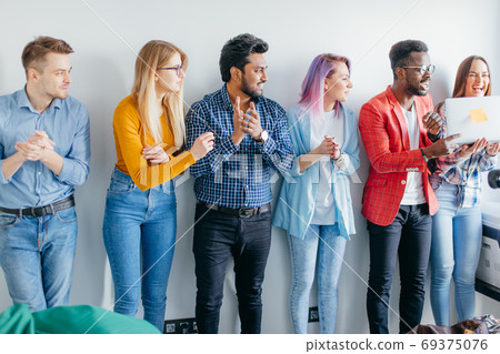 Multiethnic Group of Young People in Casual Wear isolated over grey background 69375076