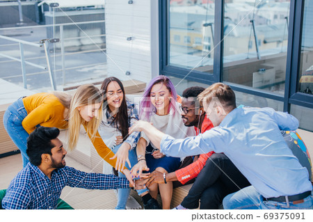 Young designers giving five after signing contract with partners abroad. Young designers giving five after signing contract with partners abroad. 69375091