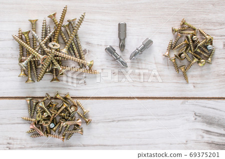 Group of Screw bolts on wooden background. 69375201