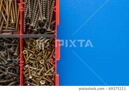 Screws and bolts in a plastic toolbox. Stock photo. Screws and bolts in a plastic toolbox. Stock photo. 69375211