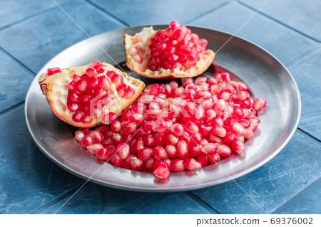 Pomegranate grains on a plate, stock photo 69376002