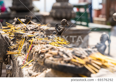 A lot of incense with small human figures A lot of incense with small human figures 69376292