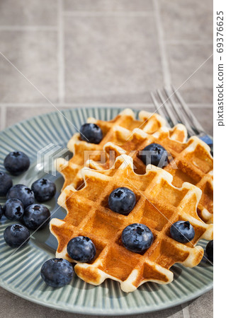 Homemade belgian waffles with fresh blueberries, close up 69376625