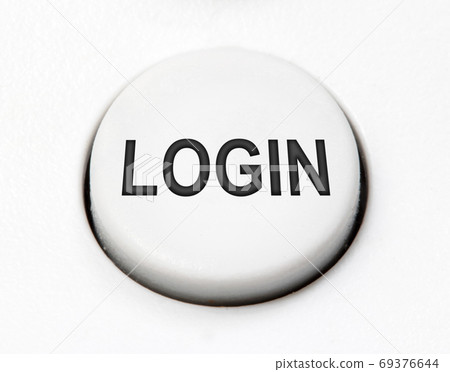 A white round button switch - log in, close up. Control mechanical key for safety access  69376644