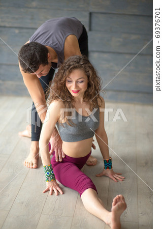 beautiful young woman sitting on the splits in the gym beautiful young woman sitting on the splits in the gym 69376701