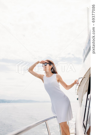 Young sexy woman on her private yacht at sunset 69377086
