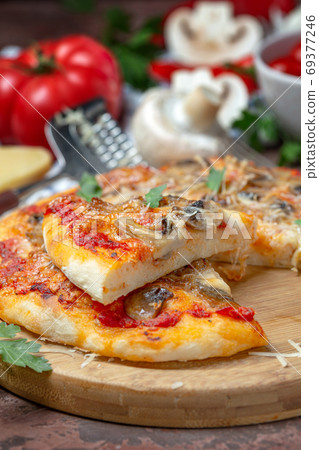 Pizza with vegetables, mushrooms and cheese. Pizza with vegetables, mushrooms and cheese. 69377246