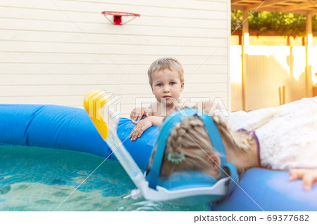 Cute adorable caucasian blond little girl making 69377682