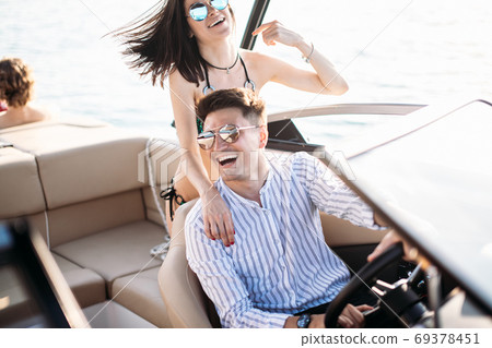 Young married couple having sea excursion on motor boat 69378451