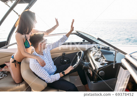 Young married couple having sea excursion on motor boat 69378452