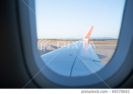 The picture of plane wing from the plane window view The picture of plane wing from the plane window view 69378681