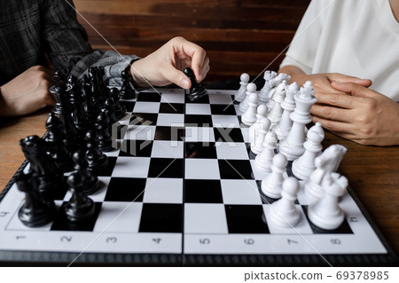 Business women play chess on board with white background 69378985