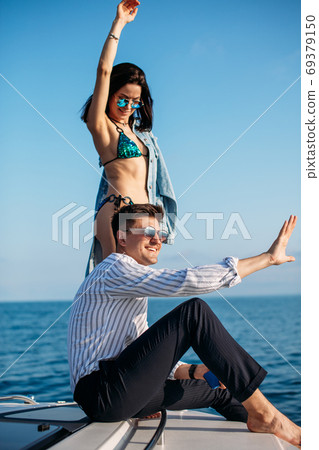 Caucasian couple in love relaxing on yacht bow, Travelling lifestyle concept 69379150