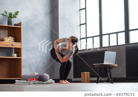 Parivritta Utkatasana or Chair Twist yoga pose Parivritta Utkatasana or Chair Twist yoga pose 69379151