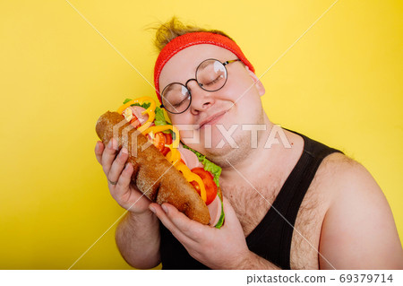 funny man hugs a huge burger 69379714