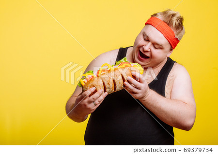 fat man eating fast food hamberger fat man eating fast food hamberger 69379734