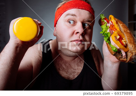 Fat man choise between sport and fastfood Fat man choise between sport and fastfood 69379895