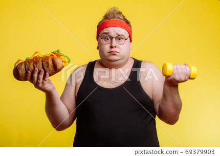 Fat man choise between sport and fastfood 69379903