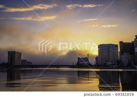 Sunset over the Kushiro River and flowing clouds Sunset over the Kushiro River and flowing clouds 69381059