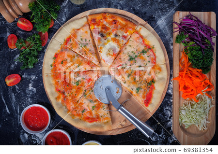 Salmon Seafood Pizza on a Black table with ingredients around Salmon Seafood Pizza on a Black table with ingredients around 69381354