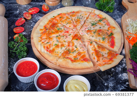 Salmon Seafood Pizza on a Black table with ingredients around Salmon Seafood Pizza on a Black table with ingredients around 69381377