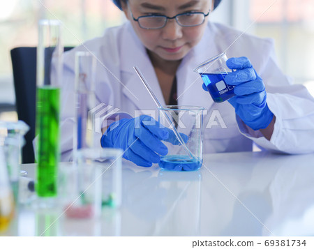 Senior scientists are mixing 2 types of solutions Senior scientists are mixing 2 types of solutions 69381734