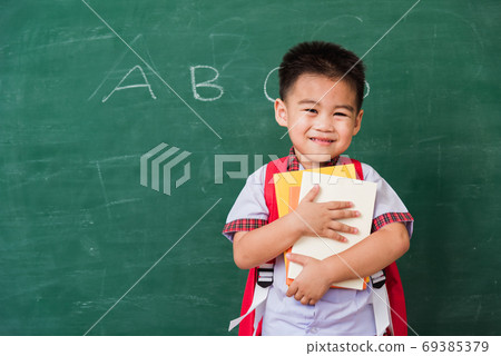 Child boy from kindergarten in student uniform with school bag a Child boy from kindergarten in student uniform with school bag a 69385379
