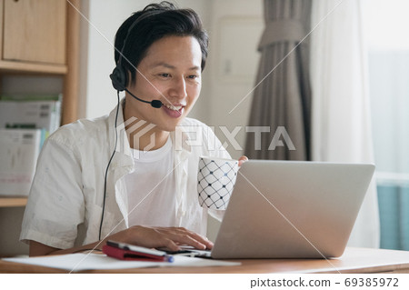 Image of a Japanese man working at home for telework, remote work, and work from home Image of a Japanese man working at home for telework, remote work, and work from home 69385972