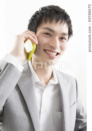 A businessman calling with a smartphone A businessman calling with a smartphone 69386670