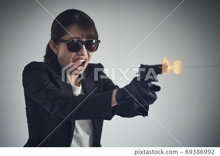 A woman with a gun 69386992