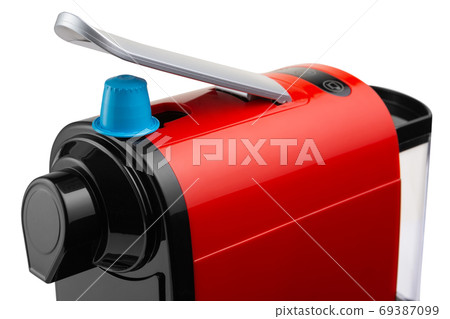 element of a red capsule coffee machine and a blue capsule with coffee powder, on a white background, close-up shot 69387099