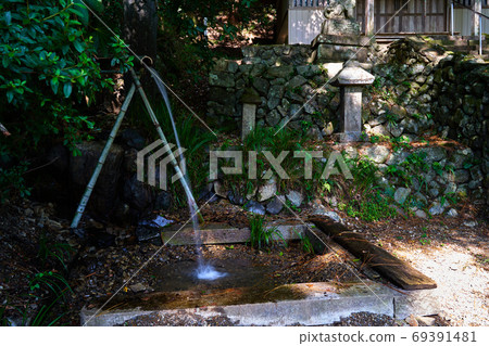 A small shrine in a mountain village where spring water pours. A small shrine in a mountain village where spring water pours. 69391481
