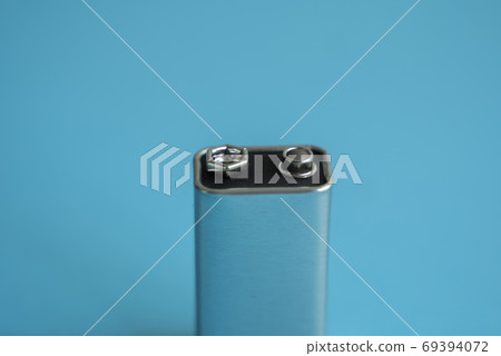 High voltage battery on a blue background. Silver Volt battery. 9V Advanced Lithium Batteries. High voltage battery on a blue background. Silver Volt battery. 9V Advanced Lithium Batteries. 69394072