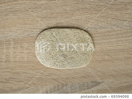 Natural loofah kitchen dish washing sponges. Eco friendly dishwashing sponge on a table, top view. Biodegradable dishwashing scrub pad. 69394098