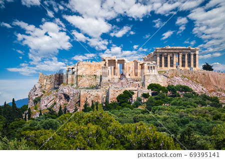 Great view of Acropolis hill from Pnyx hill on summer day with great clouds in blue sky, Athens, Greece. UNESCO world heritage. Propylaea, Parthenon. Great view of Acropolis hill from Pnyx hill on summer day with great clouds in blue sky, Athens, Greece. UNESCO world heritage. Propylaea, Parthenon. 69395141