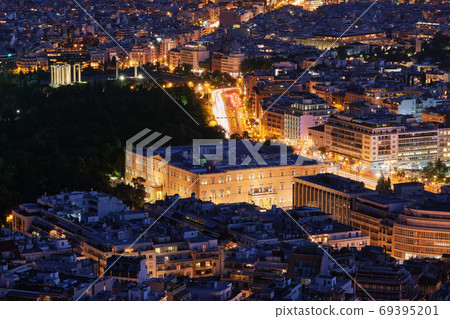 Night view Hellenic Parliament in Syntagma square brightly lit up and ruins of temple of Olympian Zeus behind it shot from hill of Lycabettus, Night view Hellenic Parliament in Syntagma square brightly lit up and ruins of temple of Olympian Zeus behind it shot from hill of Lycabettus, 69395201
