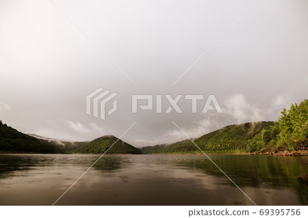 Mirror smooth water of the carpathian Zetelaka lake. Beautyful landscape after rain Mirror smooth water of the carpathian Zetelaka lake. Beautyful landscape after rain 69395756