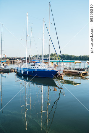 Row of yachts anchored in harbour of a European city Row of yachts anchored in harbour of a European city 69396810