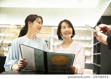 Parent and child looking at the menu Parent and child looking at the menu 69396914