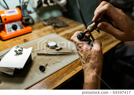 close-up. The jeweler makes a silver ring close-up. The jeweler makes a silver ring 69397417