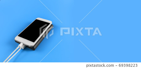 Top view smartphone charging with power bank on blue background 69398223